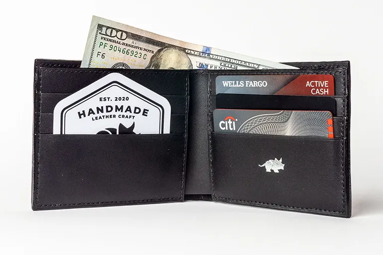Open handmade leather wallet with cash